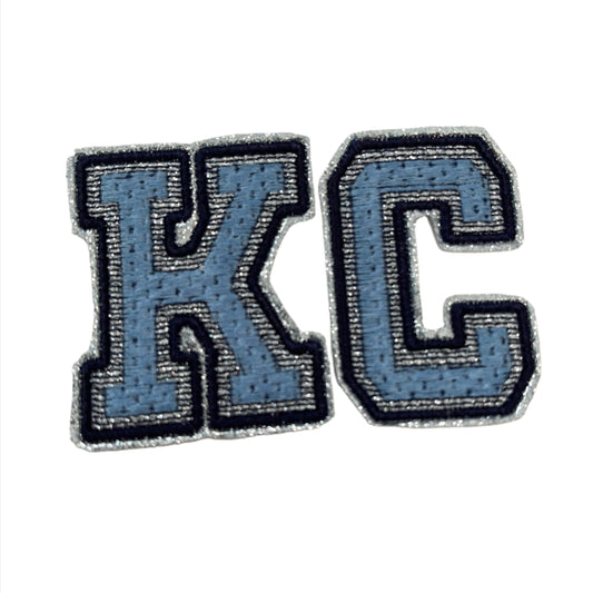 KC iron-on patch in Kansas City Royals and Sporting KC colors.