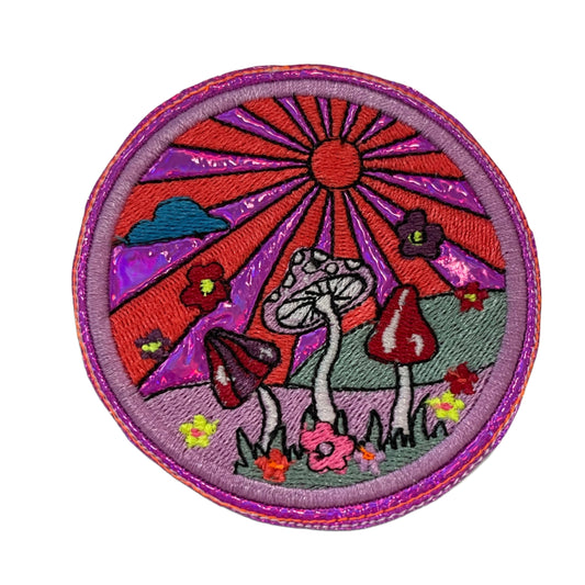 Handmade Mushroom Sunset Iron-On Patch with purple holographic background and colorful embroidery.