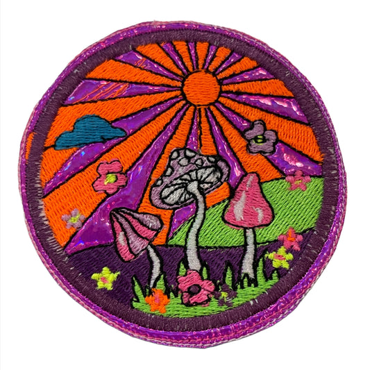 Handmade Mushroom Sunset Neon Iron-On Patch with holographic purple background, featuring vibrant neon mushrooms and a sun with pink and orange rays.