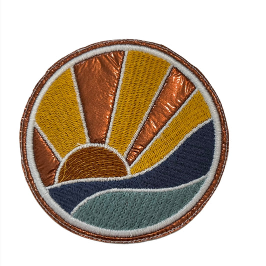 Handmade Sunset Over Ocean iron-on patch with copper metallic background.