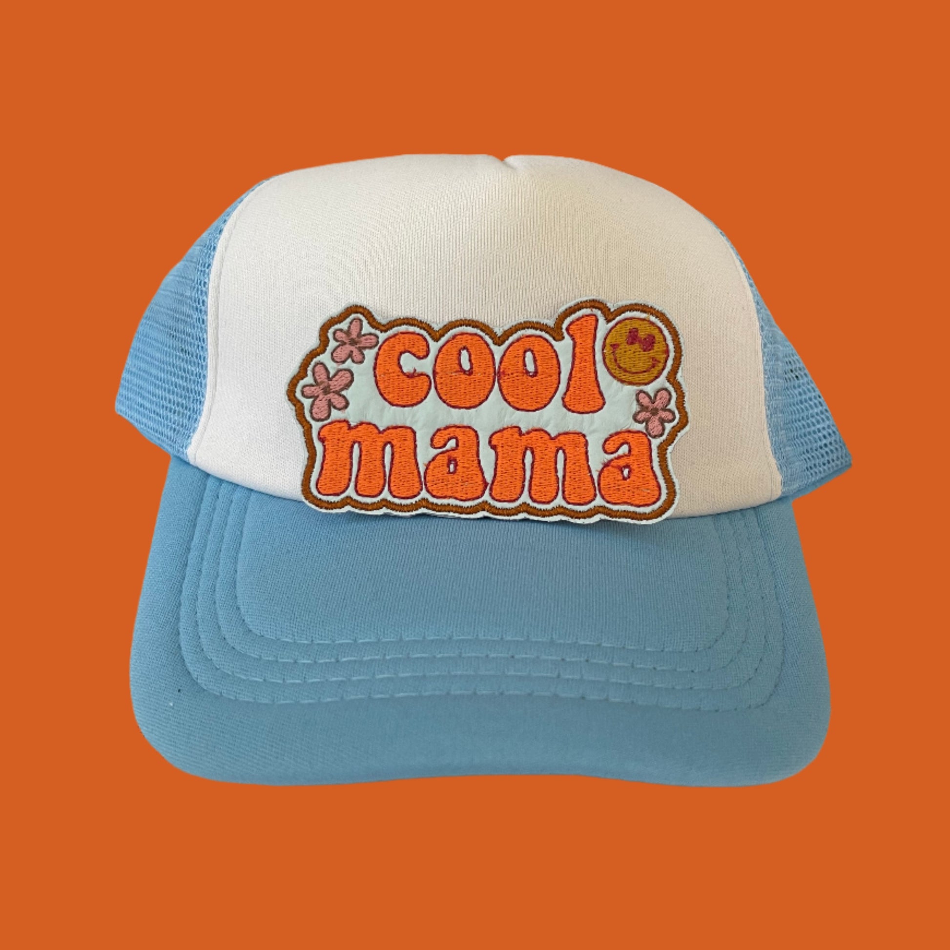 Iron-on patch featuring vibrant orange "cool mama" text with playful flower accents and a smiley face, showcasing a funky and retro design.