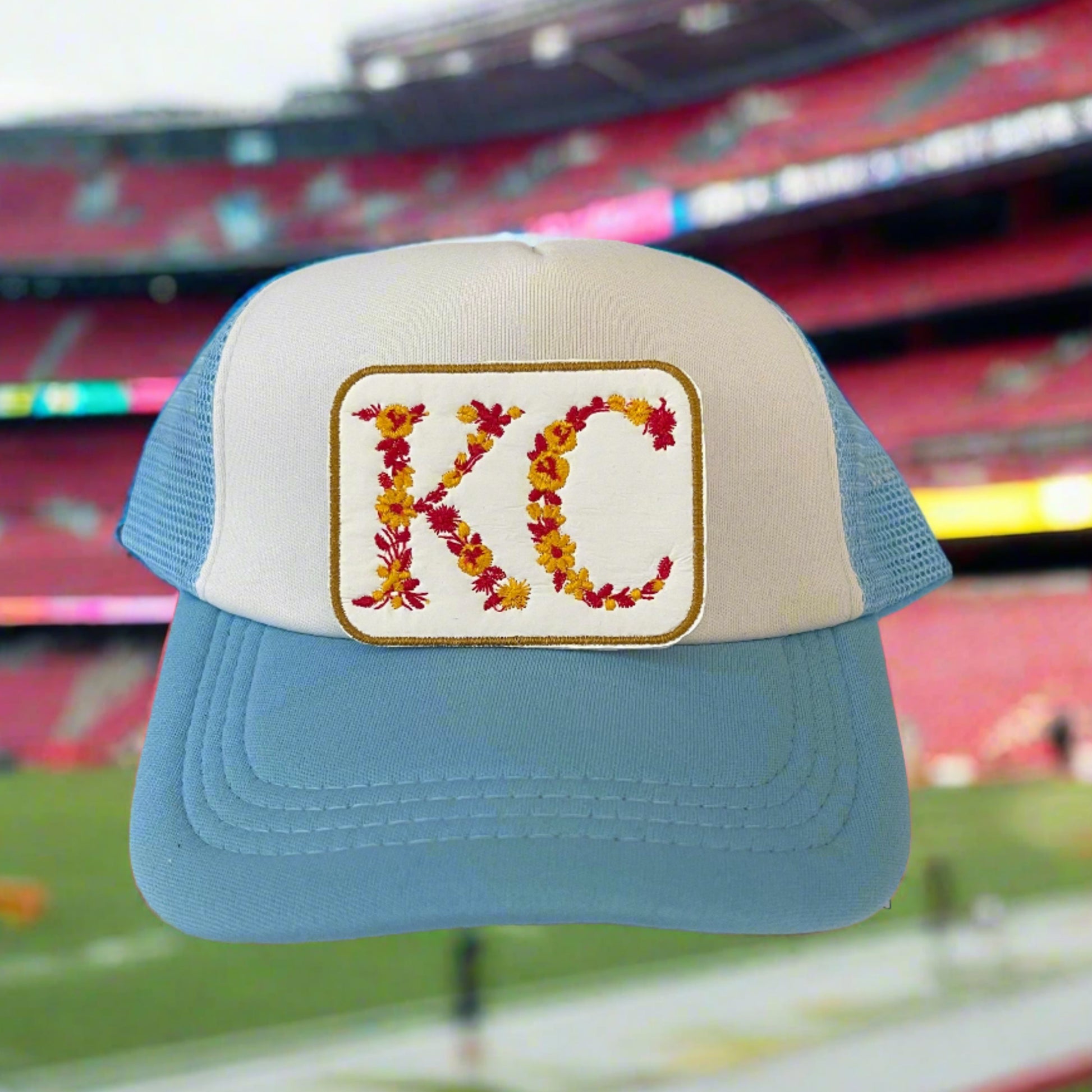 Iron-on patch featuring the letters "KC" adorned with vibrant flowers, showcasing a stylish and artistic retro design.