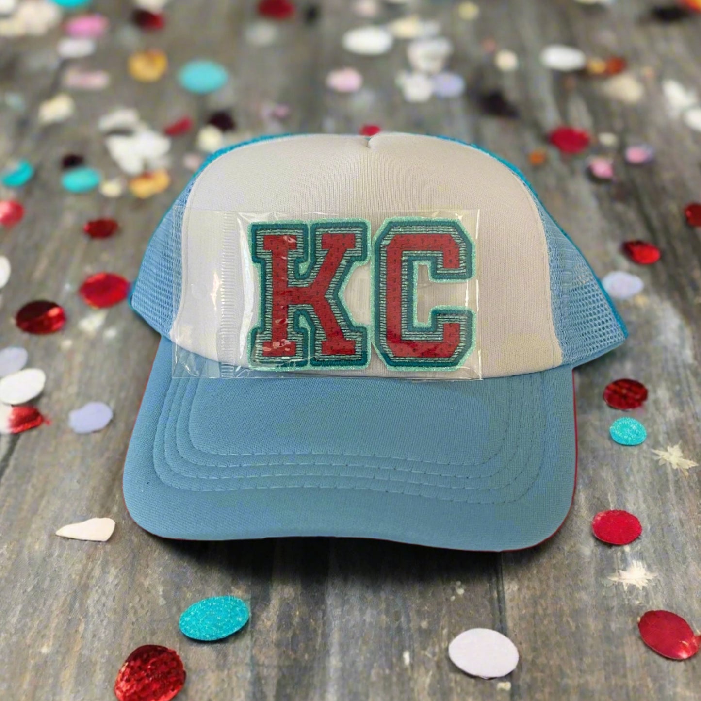 Iron-on patch featuring bold "KC" letters in Kansas City Current team colors, showcasing a stylish and vibrant aesthetic.