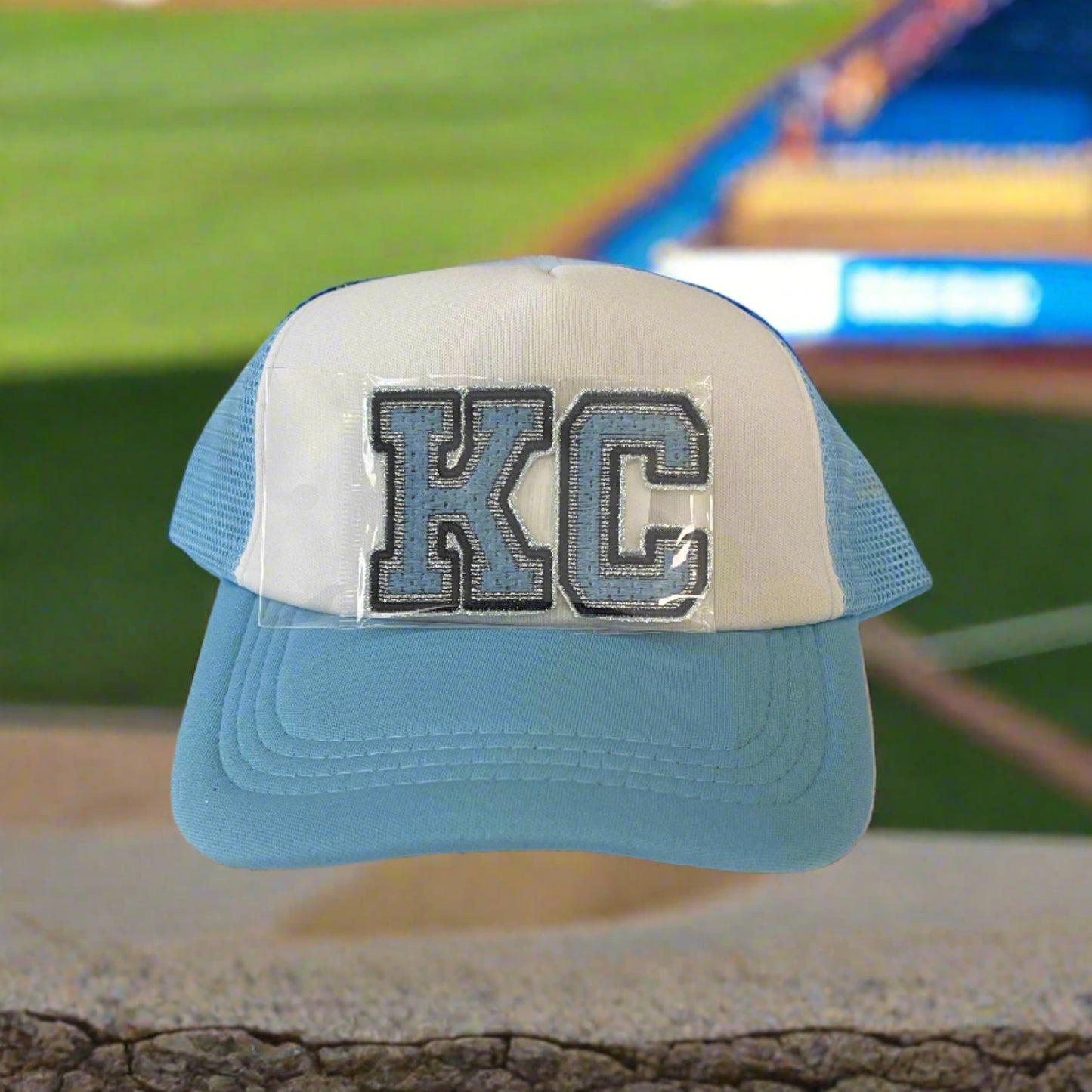 Iron-on patch featuring bold "KC" letters in Kansas City Royals and Sporting KC colors, showcasing a stylish and vibrant aesthetic.