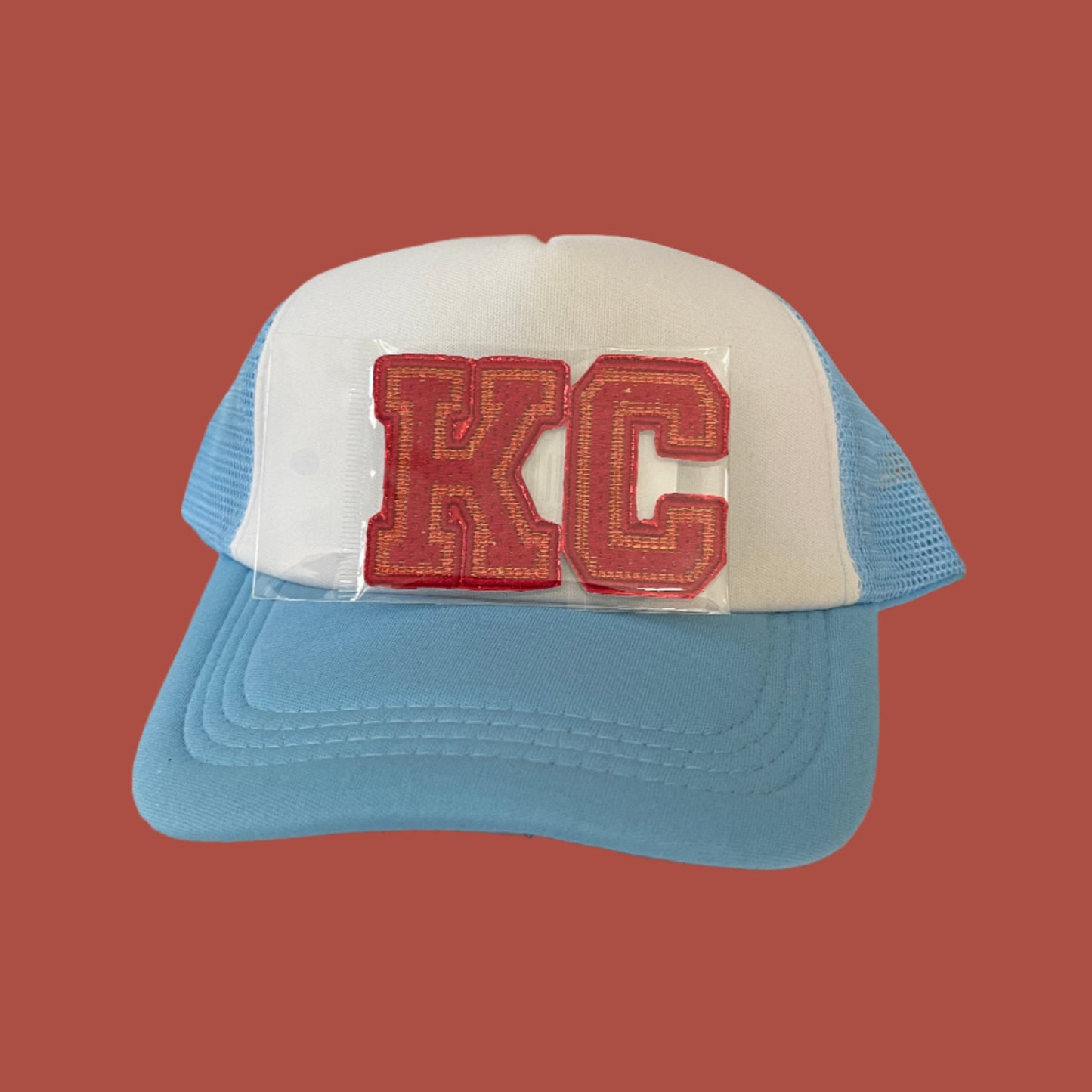 Iron-on patch featuring bold "KC" letters in Kansas City Chiefs colors, showcasing a stylish and vibrant aesthetic.