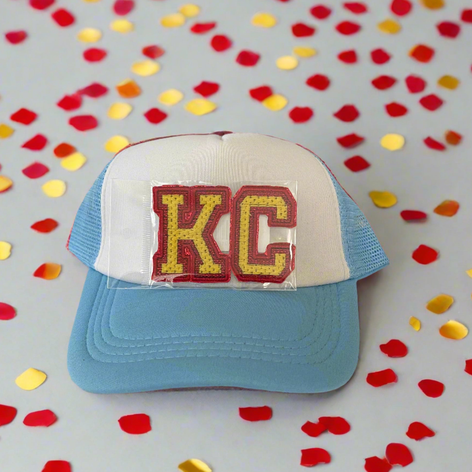 Iron-on patch featuring bold "KC" letters in Kansas City Chiefs colors, showcasing a stylish and vibrant aesthetic.