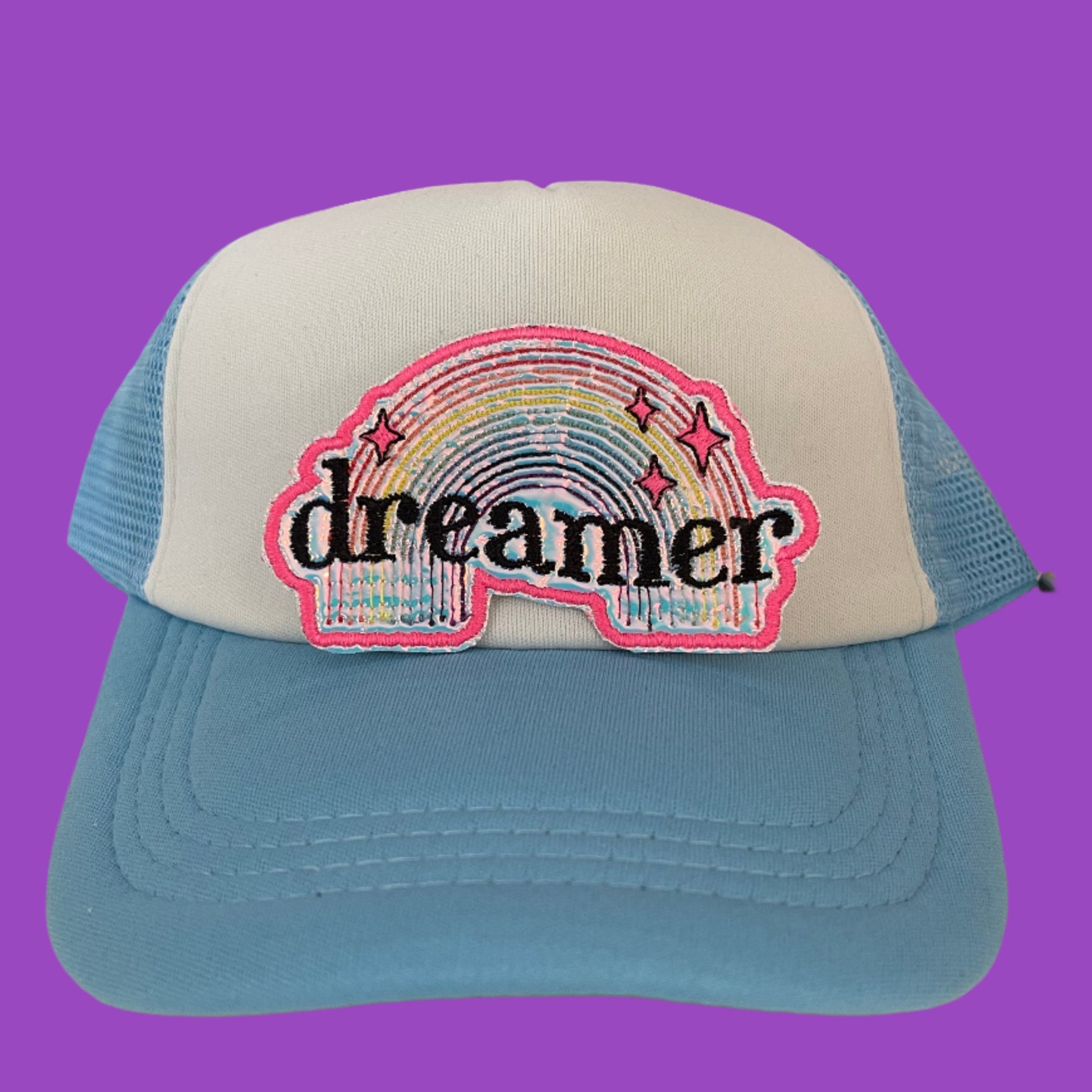 Dreamer embroidered patch featuring a colorful rainbow and whimsical stars, perfect for customizing clothing and accessories.