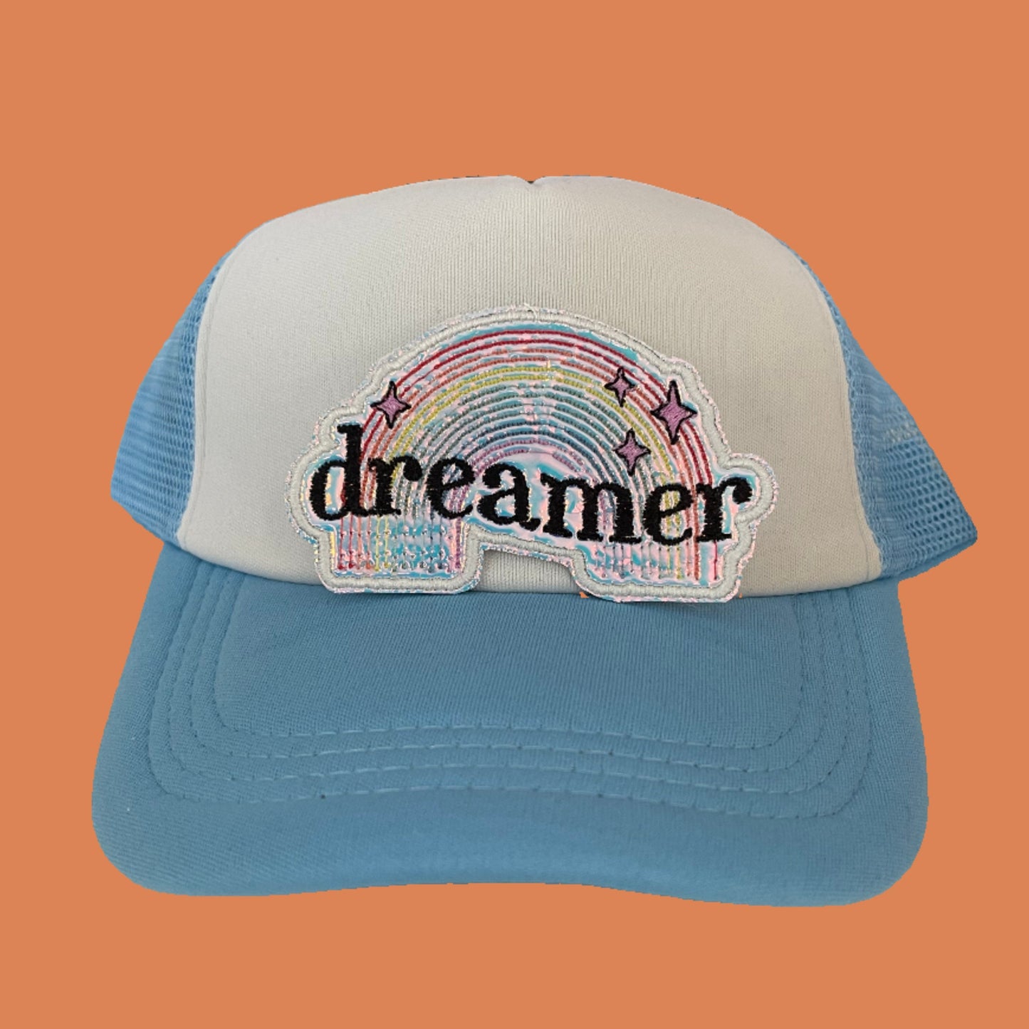 Dreamer embroidered patch featuring a colorful rainbow and whimsical stars, perfect for customizing clothing and accessories.