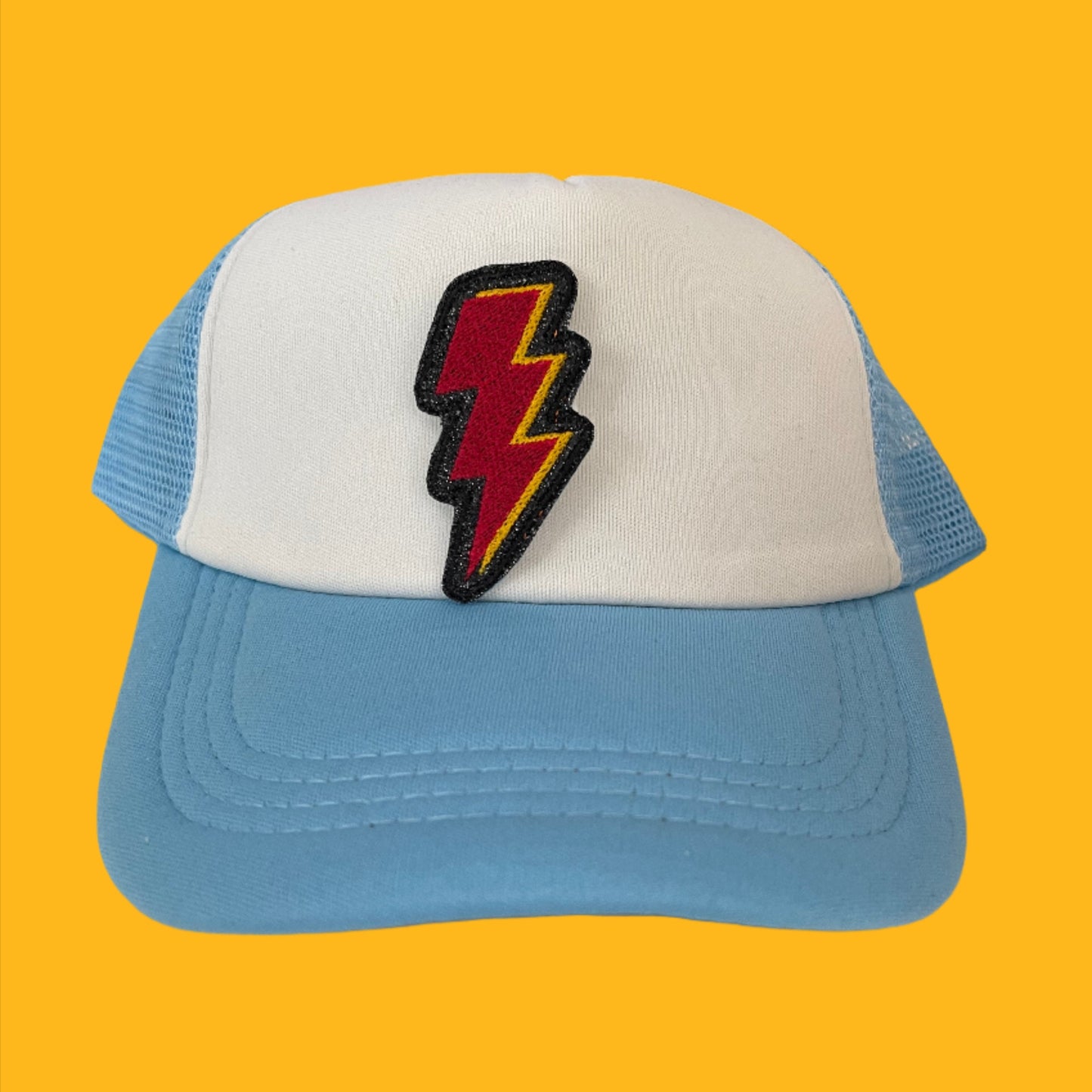 Close-up of a Kansas City Chiefs Lightning Bolt embroidered patch featuring the iconic red and yellow colors, perfect for customizing hats, apparel, and various accessories.