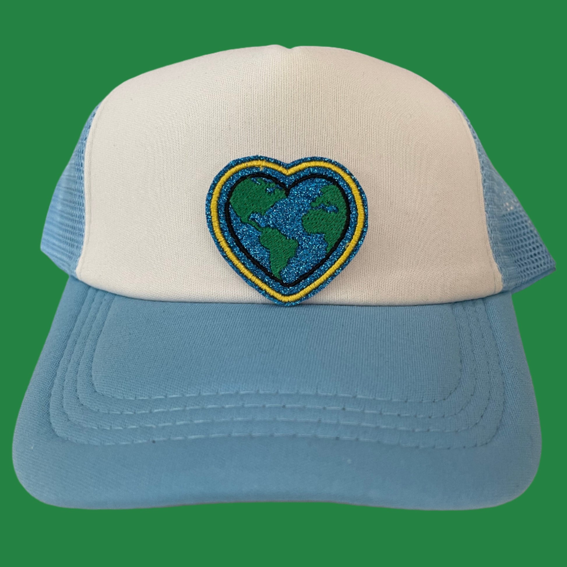 Close-up of a Heart Earth embroidered patch, featuring a heart-shaped Earth design, perfect for customizing hats, apparel, and various accessories.