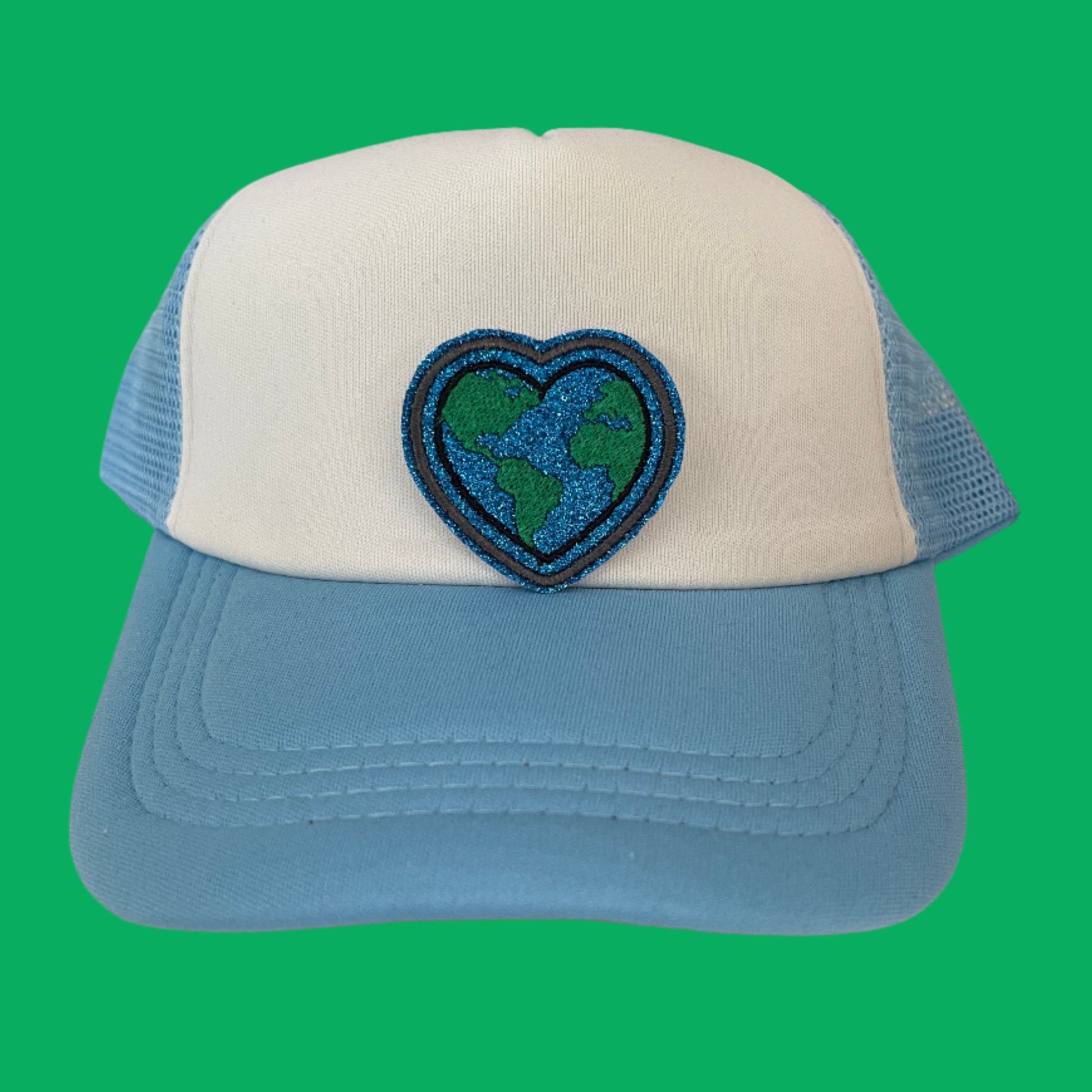 Close-up of a Heart Earth embroidered patch featuring a heart-shaped Earth design in vibrant blue and green colors, perfect for customizing hats, apparel, and various accessories.