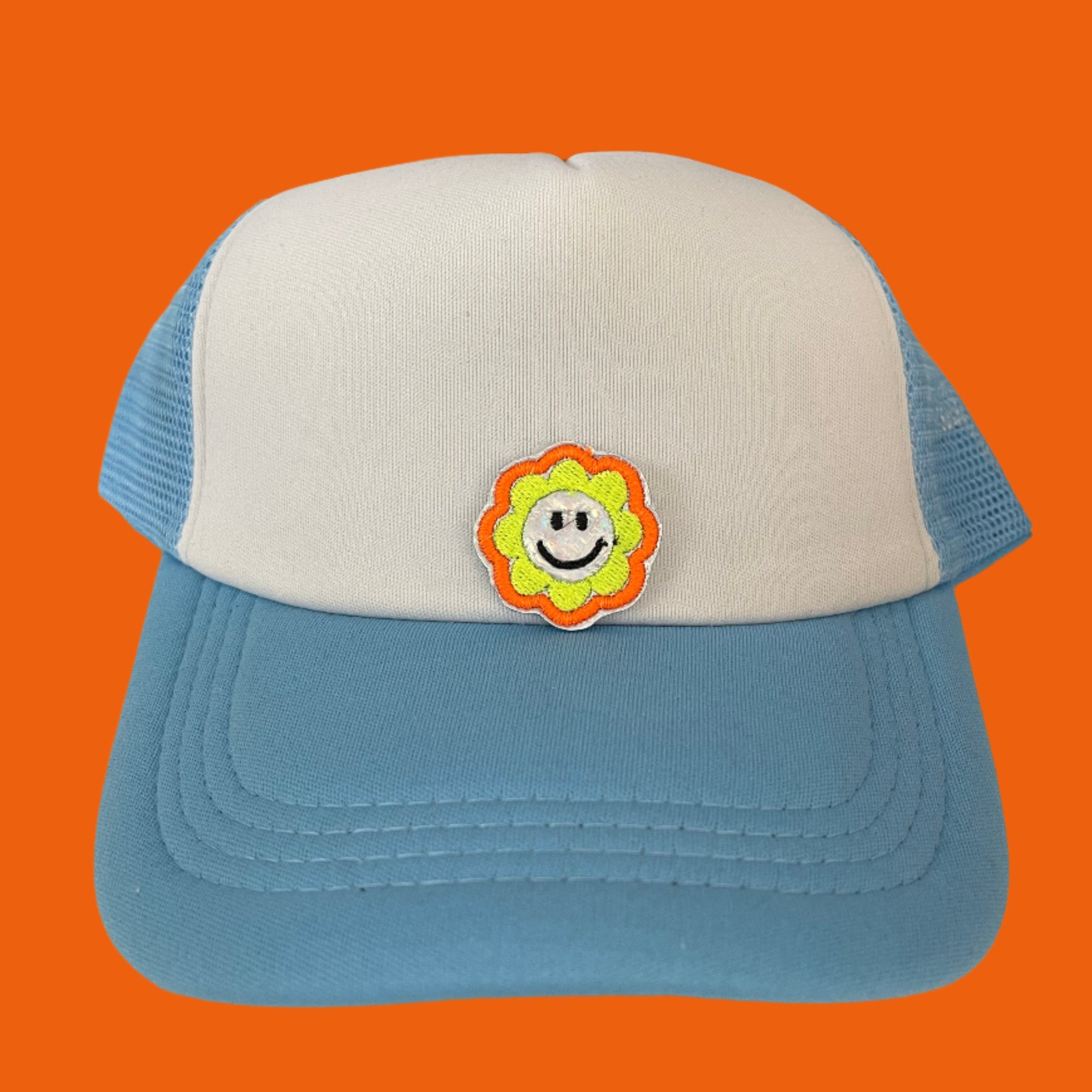 Close-up of a Bright Smiley Flower embroidered patch featuring a cheerful yellow smiley face surrounded by a colorful flower, perfect for customizing hats, apparel, and various accessories.