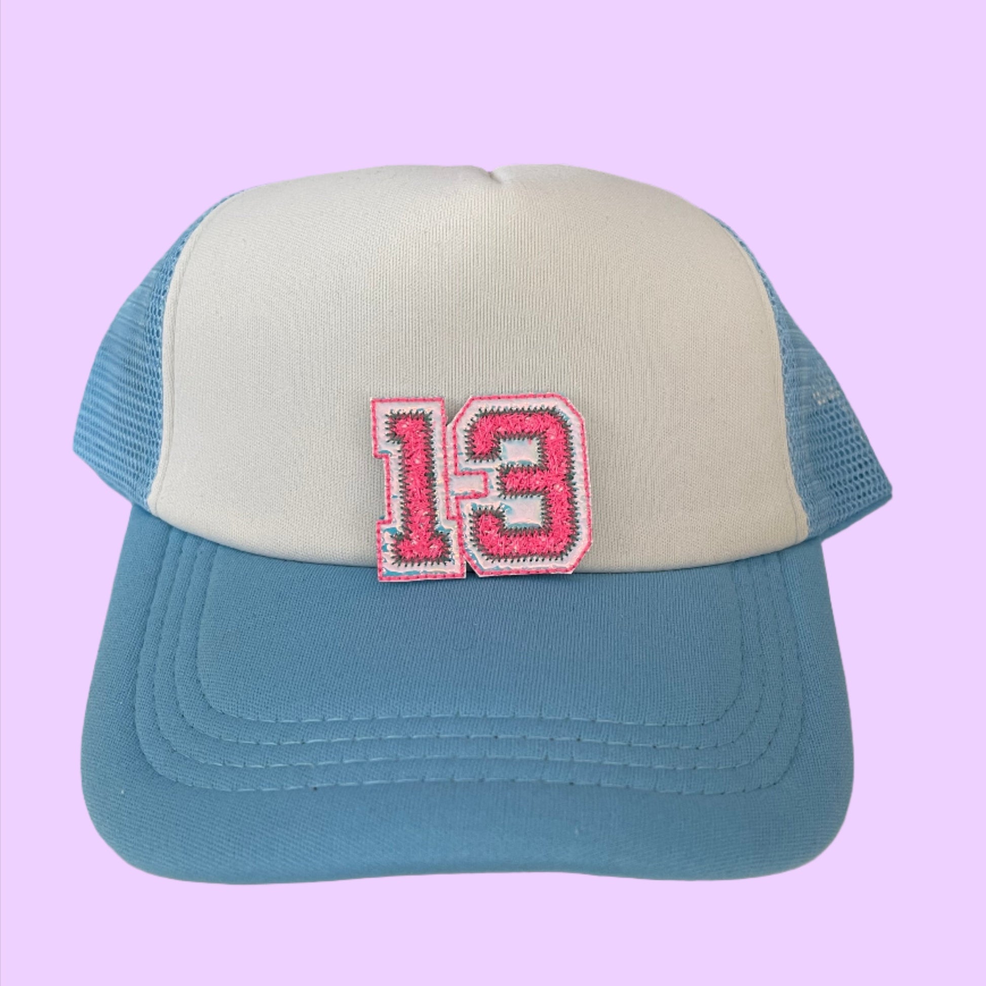 Taylor Swift Lucky 13 varsity style embroidered patch in pink and white, perfect for customizing clothing and accessories.