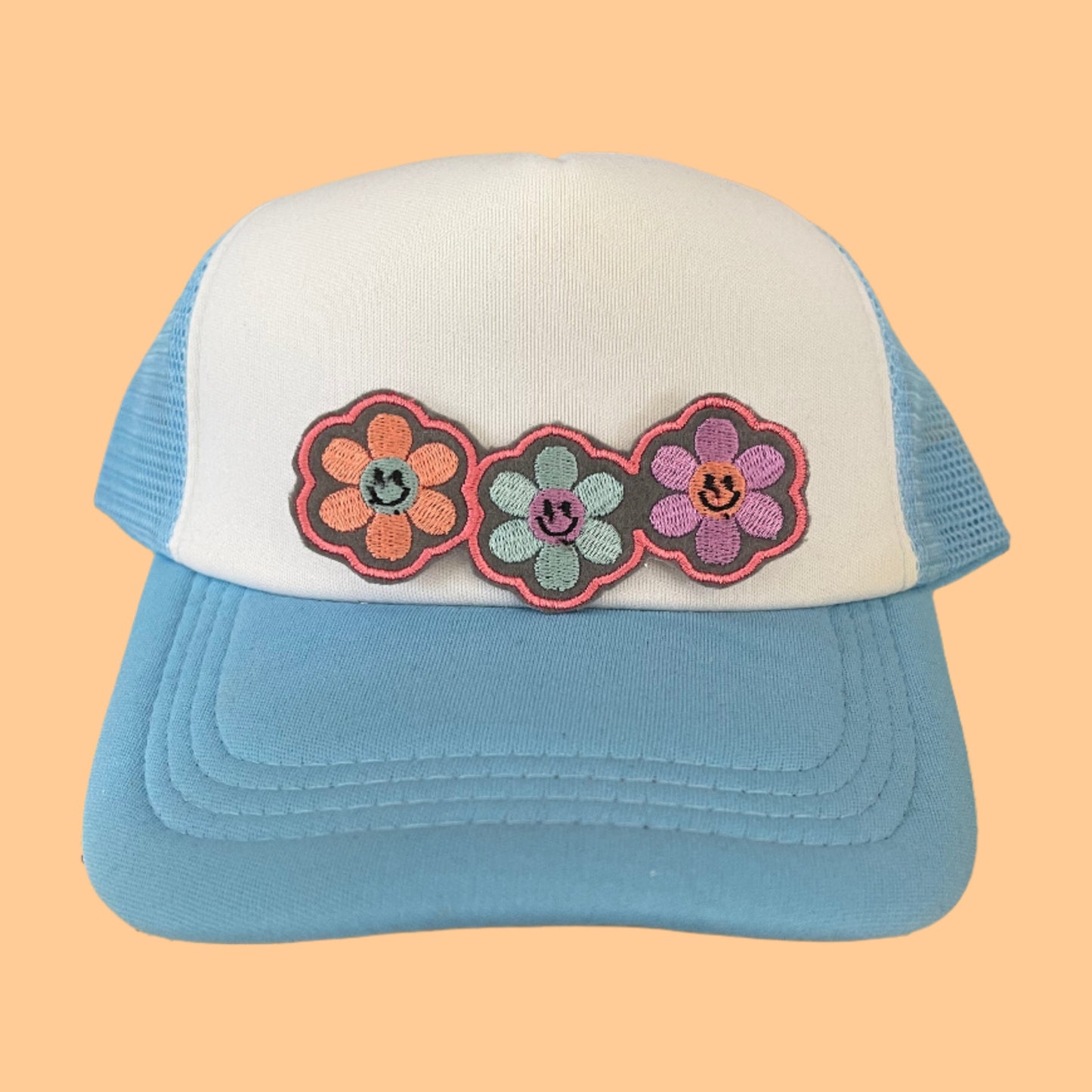 Triple Happy Flower embroidered patch with vibrant colors and smiley faces, perfect for adding a whimsical touch to various accessories.