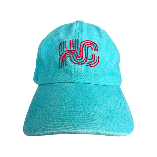 Hand embroidered red KC logo on teal hat. KC current colors.