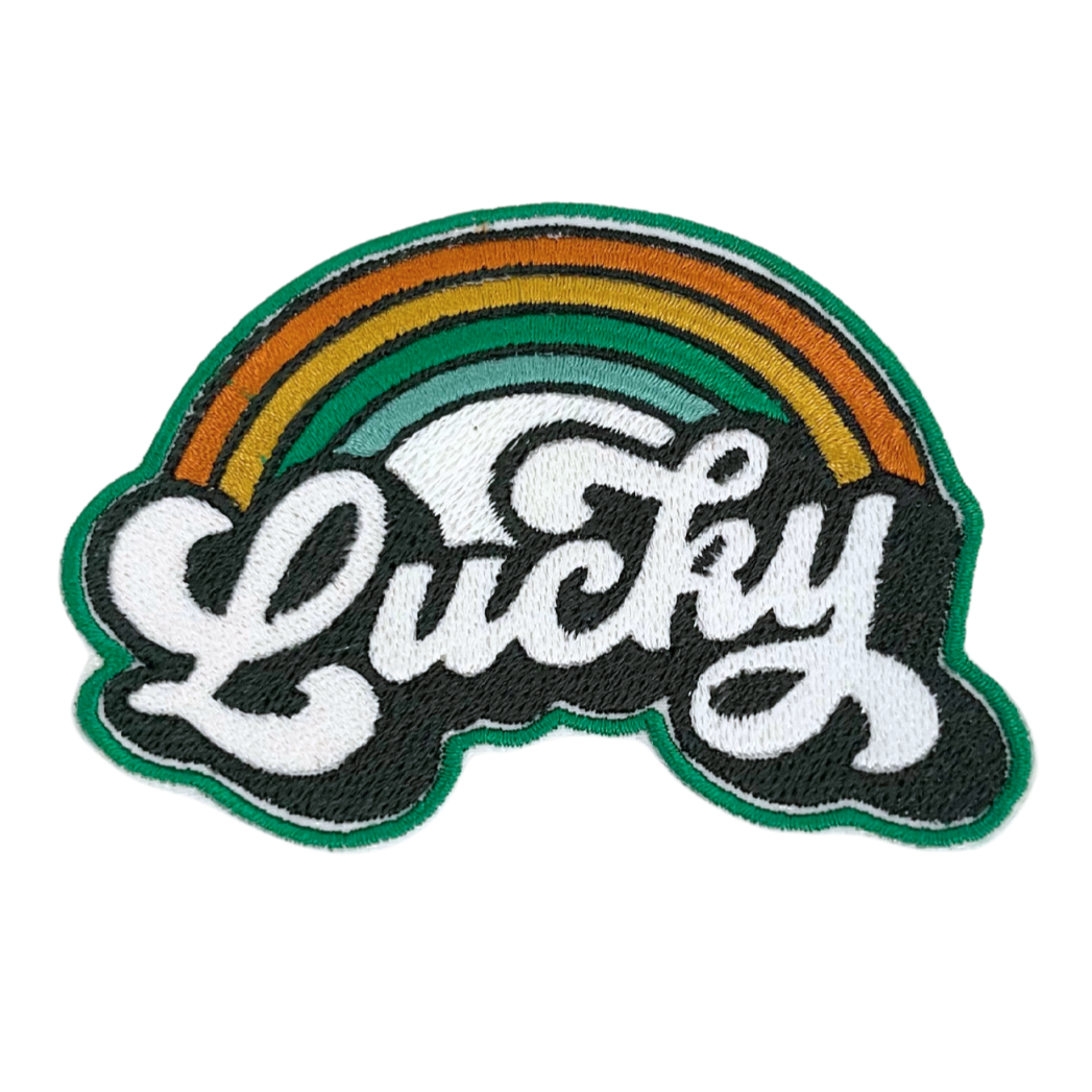 Handmade Lucky Rainbow patch with colorful rainbow and white script embroidery.