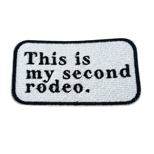 Custom embroidered patch with the text "This is my second rodeo," perfect for personalizing hats and apparel.
