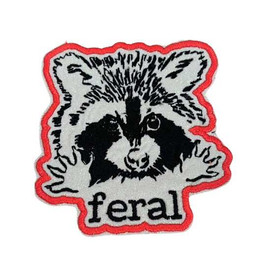 Custom embroidered patch featuring a raccoon with the word "feral," perfect for personalizing hats and apparel.