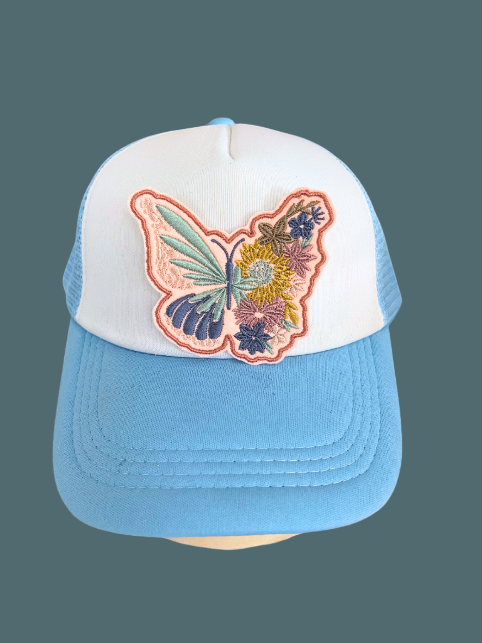 Handmade Butterfly and Floral patch with intricate embroidery on a white background.