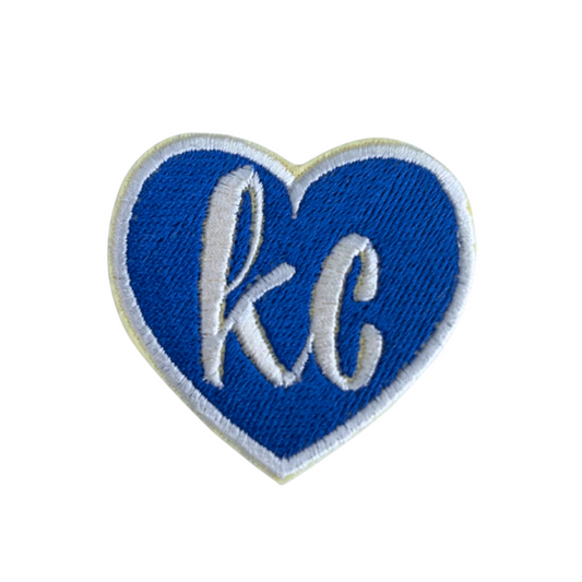 "Blue heart patch with 'KC' letters in white embroidery"