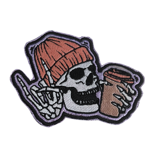 Close-up of Skull Coffee handmade patch, featuring a skull with a beanie and coffee cup.