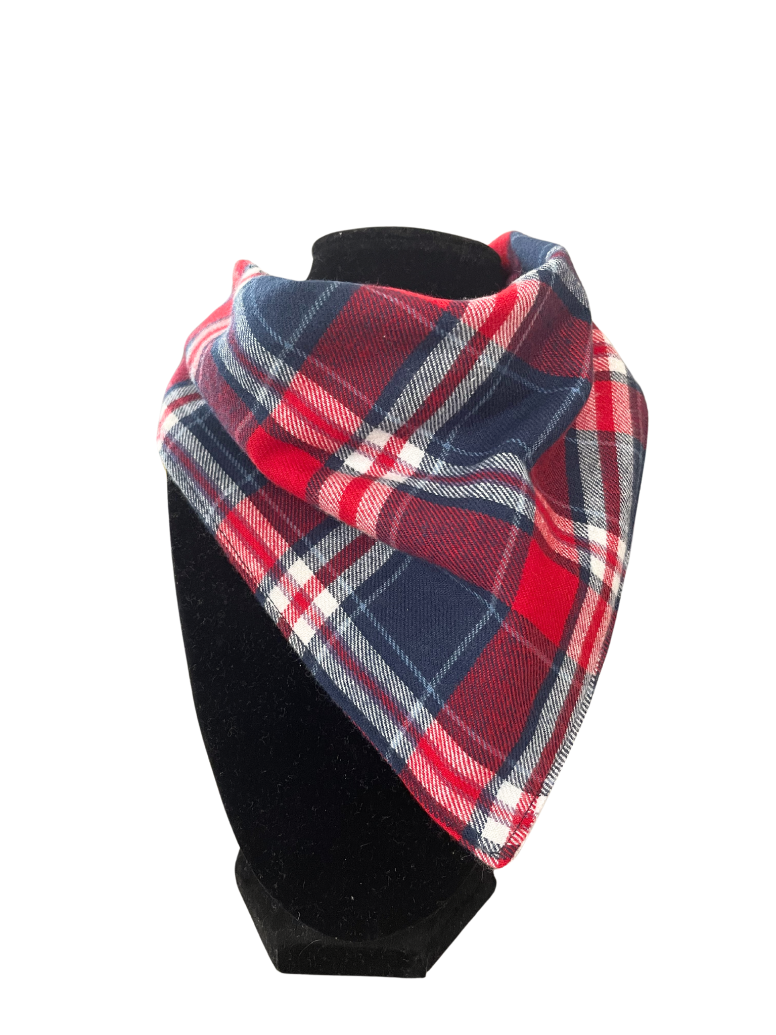 Reversible bib-dana with a red, navy, and white plaid pattern on one side and solid color cotton flannel on the reverse, displayed on a black mannequin.