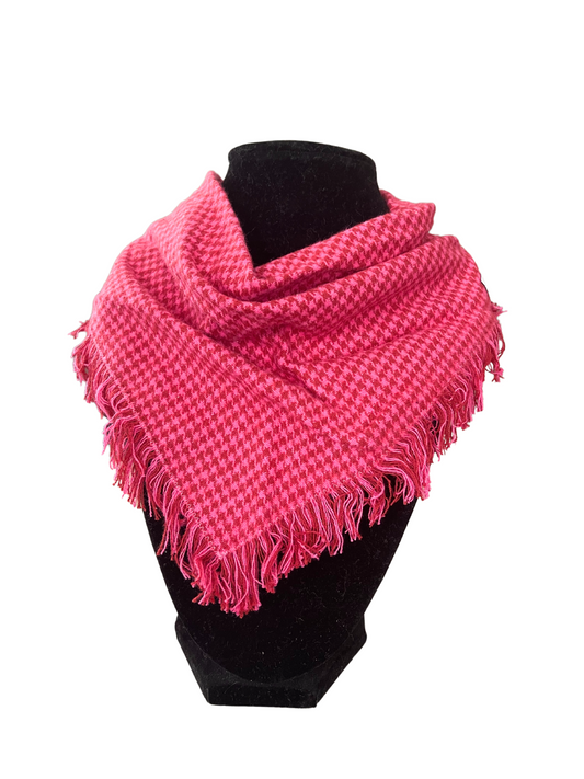 Vibrant pink houndstooth fringe bib-dana scarf with adjustable snap closures, displayed on a black mannequin.