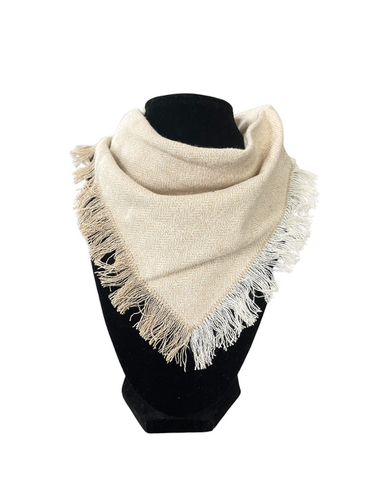 Cream fringe bib-dana scarf with a herringbone pattern and adjustable snap closures, displayed on a black mannequin.