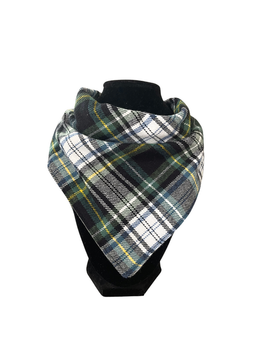 Reversible bib-dana with a classic plaid pattern in shades of green, yellow, black, and white on one side and solid color cotton flannel on the reverse, displayed on a black mannequin.