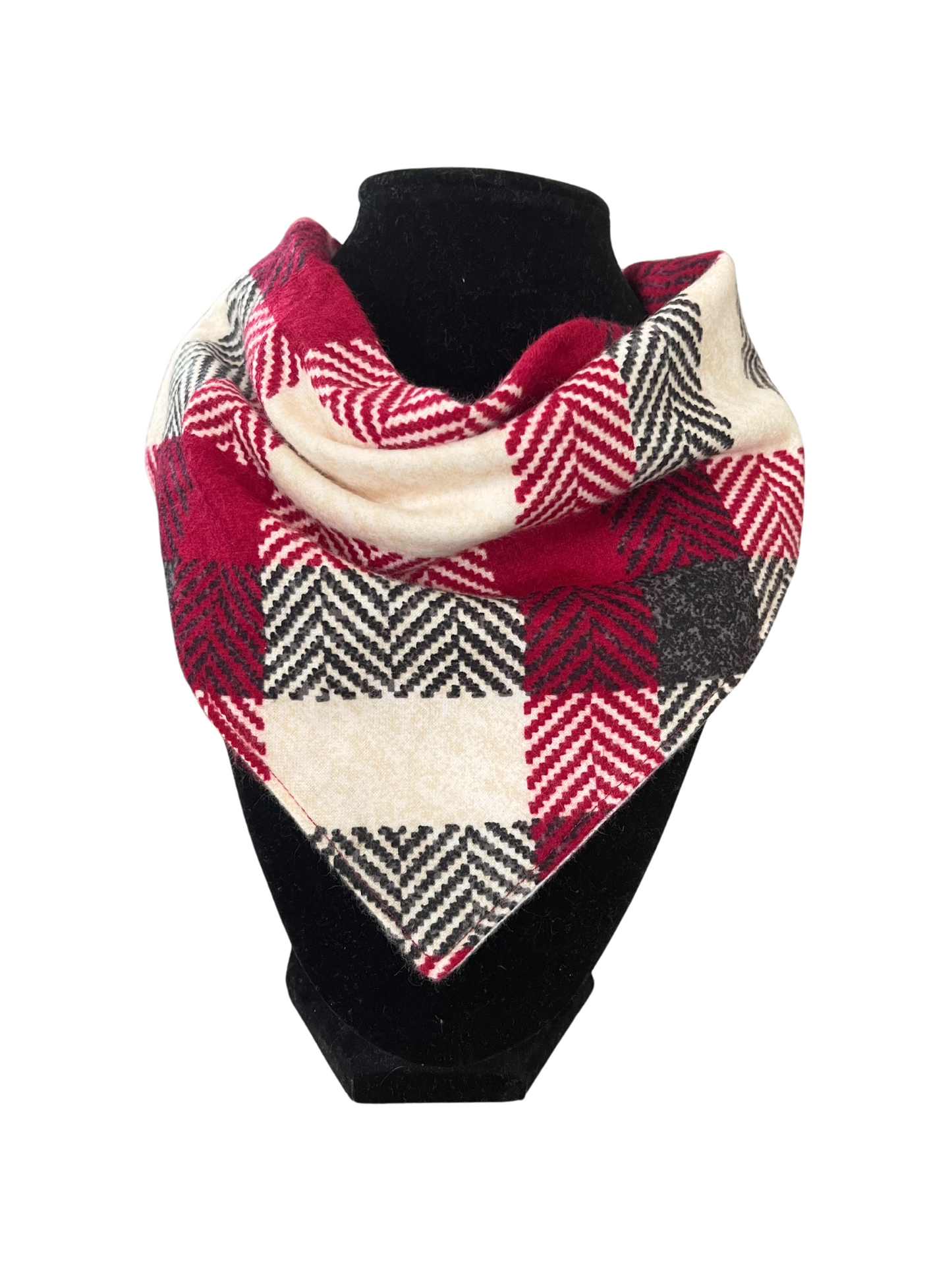 Reversible bib-dana with a red, black, and cream plaid pattern on one side and solid color cotton flannel on the reverse, displayed on a black mannequin.