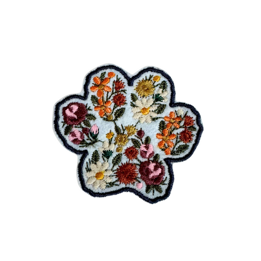 Floral paw print patch with detailed embroidery.

