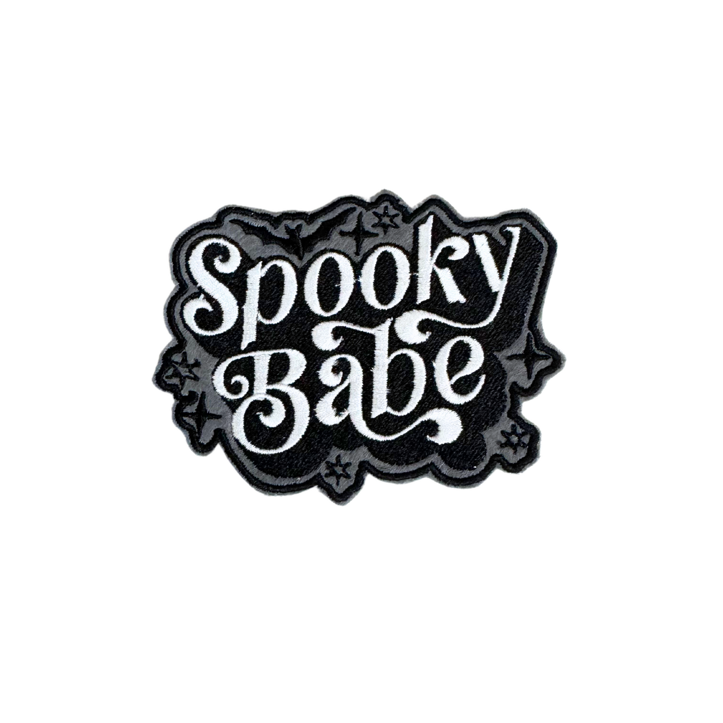 Embroidered patch with "Spooky Babe" in white gothic script on a black background.

