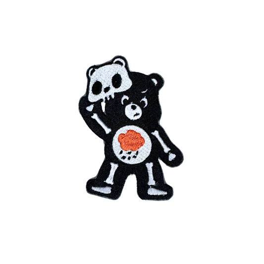 Black Skeleton Bear patch with a heart design, showcasing a spooky yet adorable vibe.

