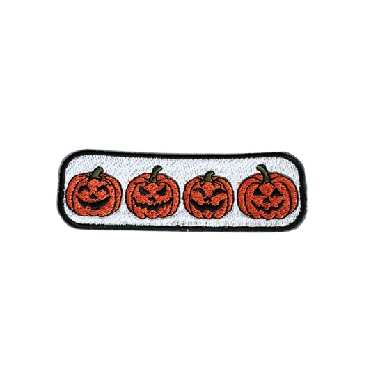 Four Jack-O'-Lanterns in a row embroidered on a white patch, perfect for Halloween-themed customization.

