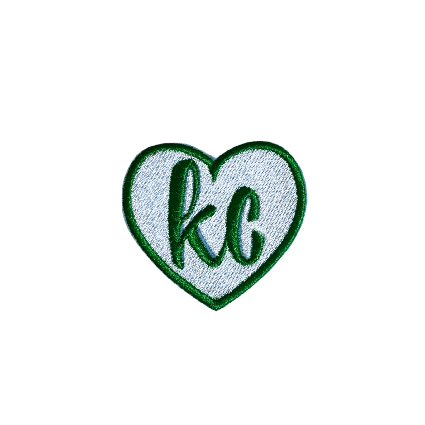 Green heart patch with "KC" in white lettering.

