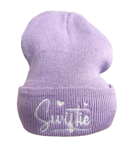 White embroidered "Swiftie" directly onto lavender beanie