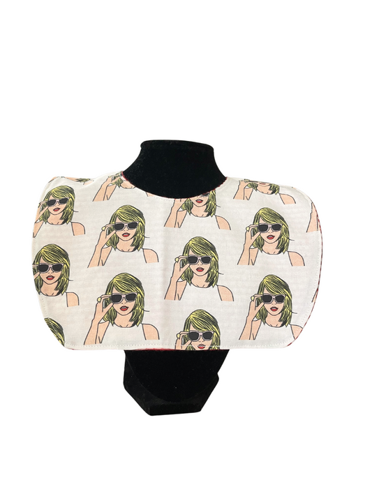 Reversible bib with pop art design featuring Taylor Swift wearing sunglasses.