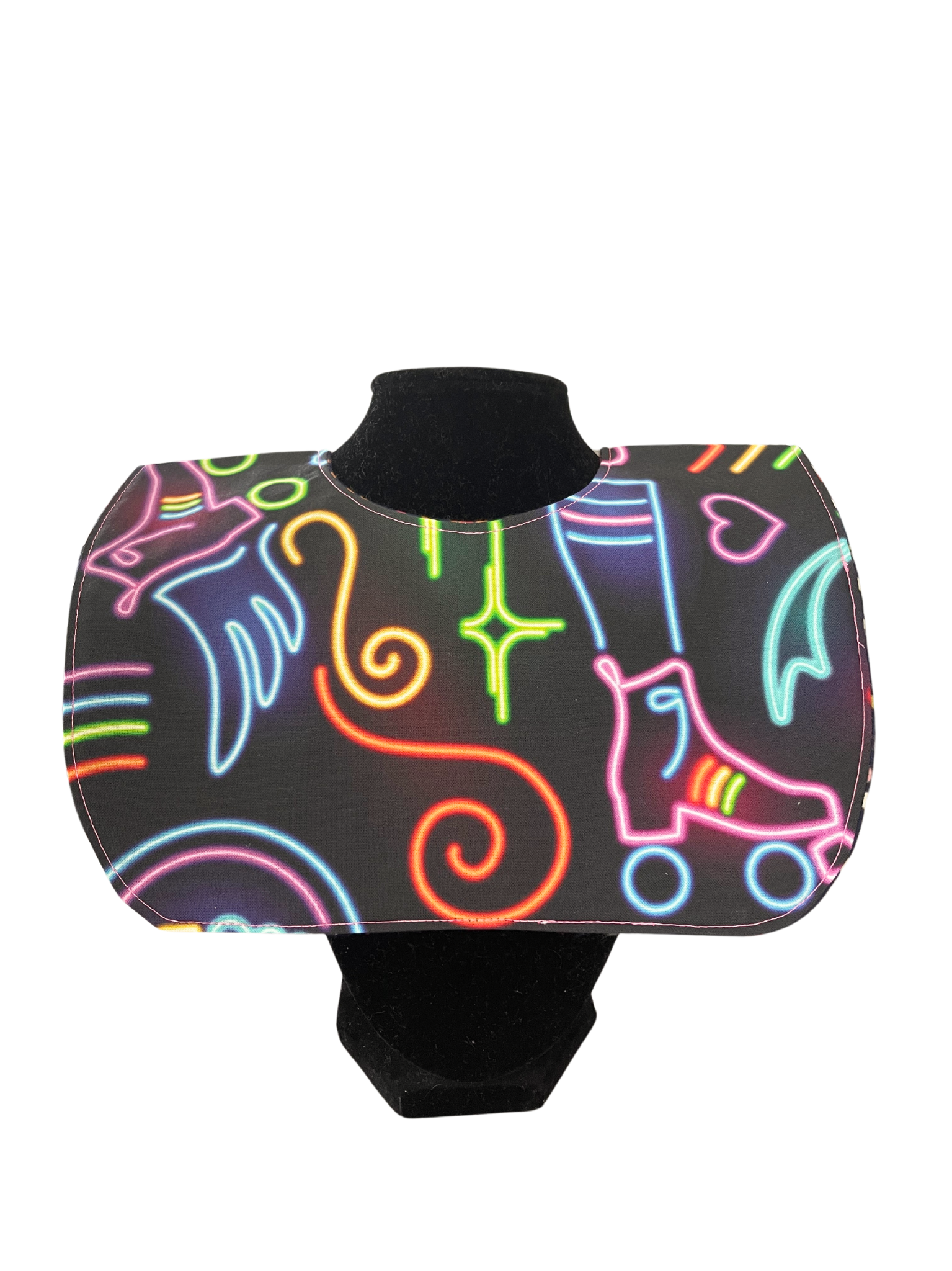 Reversible bib with neon roller skate design and polka-dotted reverse.