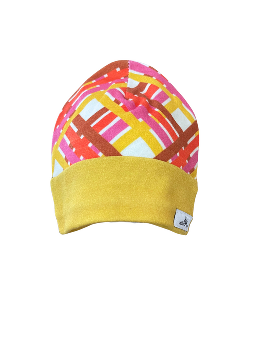 Organic cotton baby beanie with vibrant geometric design and mustard yellow cuff.