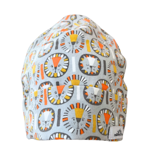 Organic cotton baby beanie with playful lion design in orange, yellow, and gray, handmade for 0-3 months.