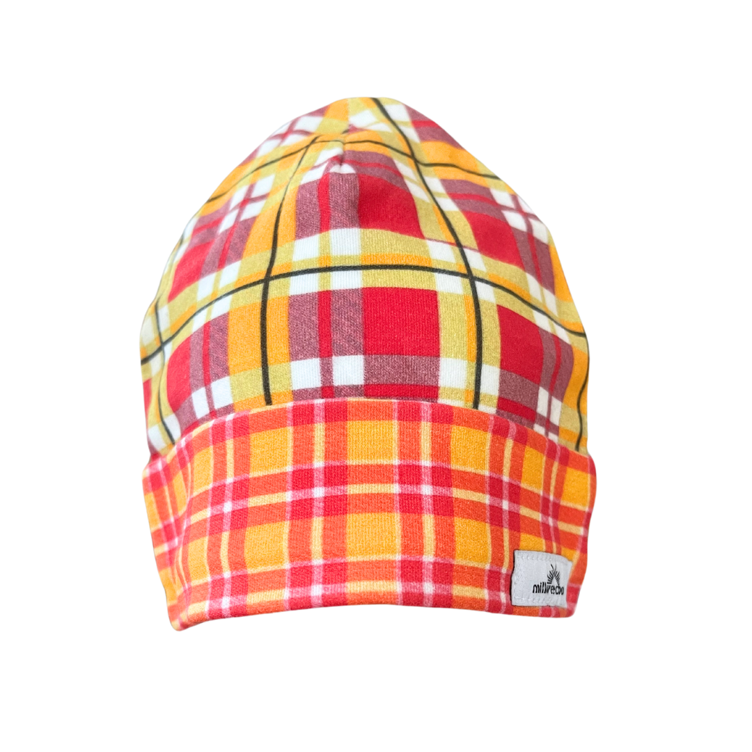 Baby beanie with bright plaid design in shades of red, yellow, orange, and white, made of organic cotton knit, suitable for 0-3 months.