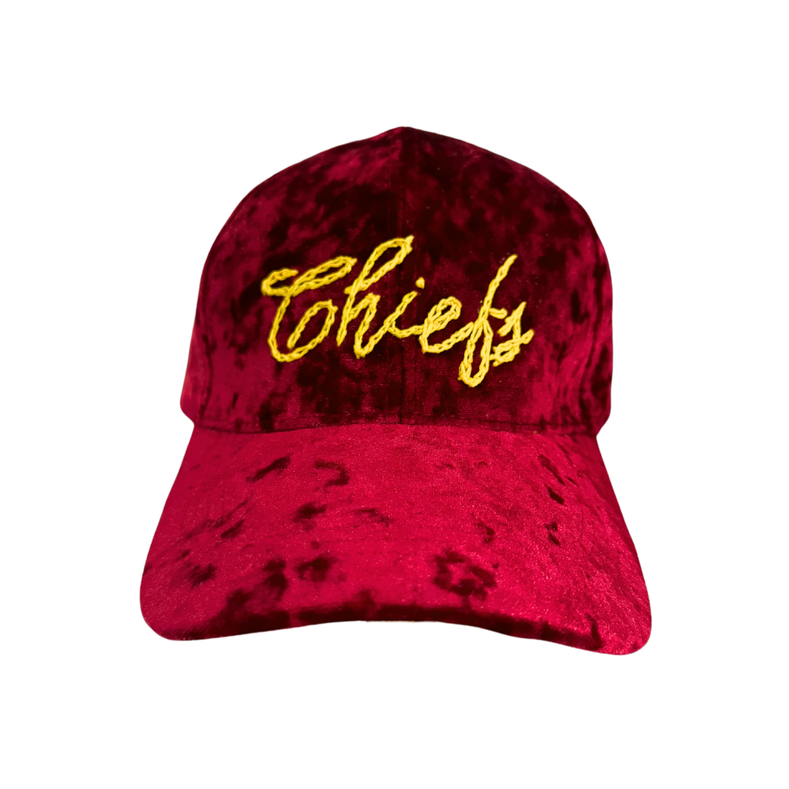 A deep red velvet hat with "Chiefs" hand-embroidered in golden yellow script across the front. The hat has a smooth texture and an adjustable strap for a customizable fit.