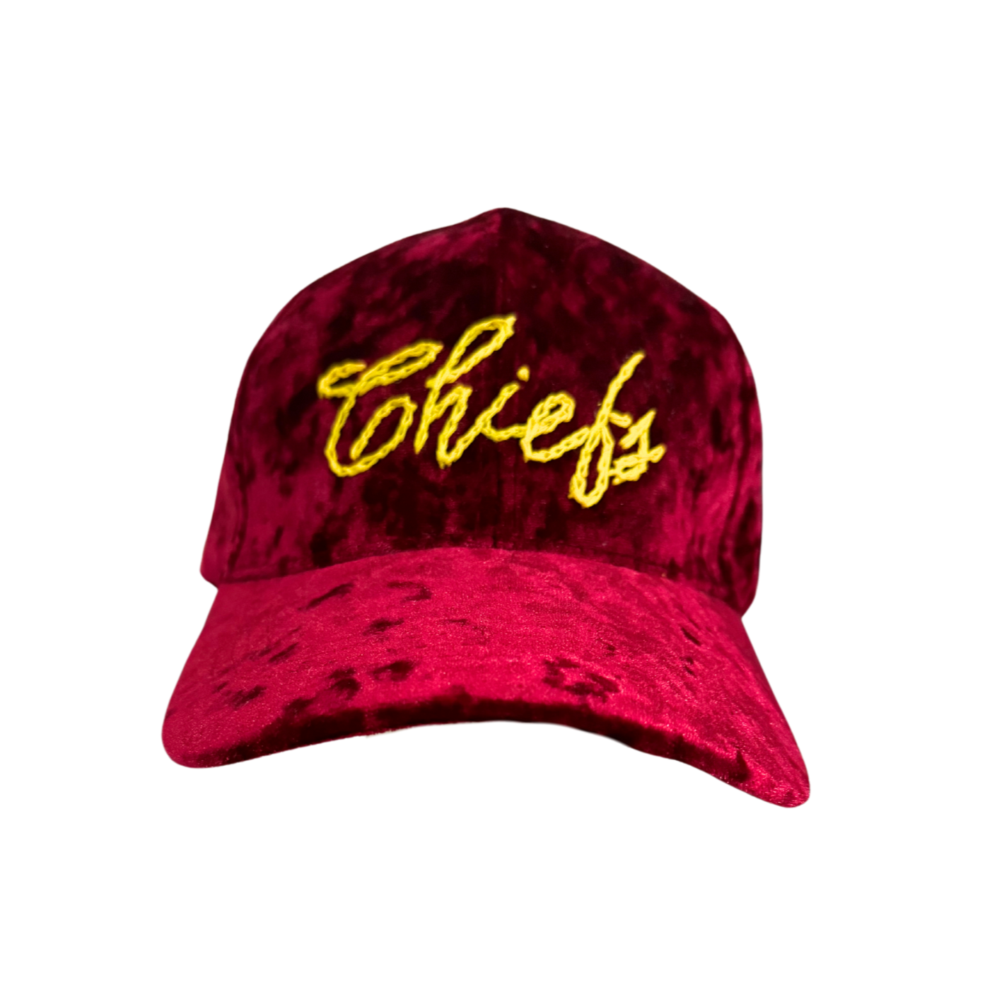 A deep red velvet hat with "Chiefs" hand-embroidered in golden yellow script across the front. The hat has a smooth texture and an adjustable strap for a customizable fit.