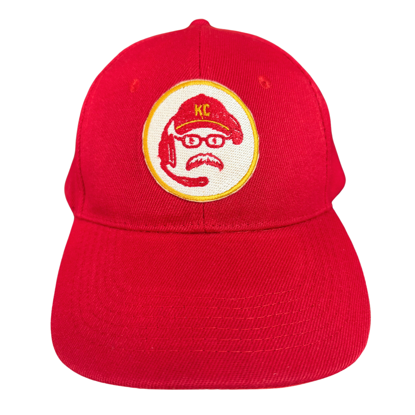 Embroidered coach patch on a red KC hat.

