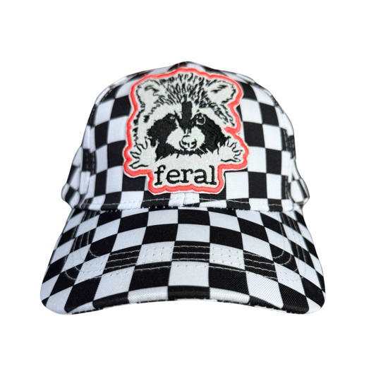 "Feral" raccoon embroidered patch on a black and white checkered hat.

