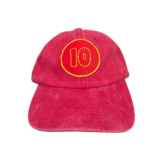 Front view of a distressed red hat featuring an embroidered yellow and red "10" patch, representing Kansas City Chiefs' Isaiah Pacheco.

