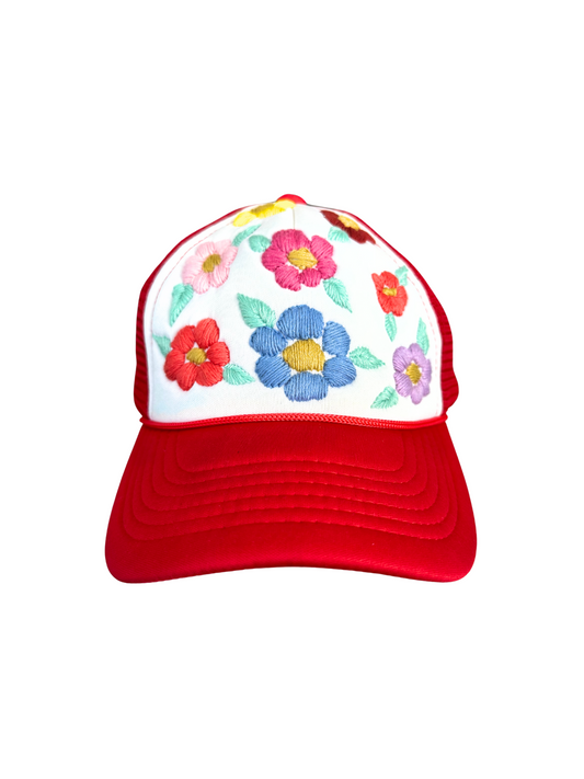 Hand-embroidered colorful flowers on red and white trucker hat.

