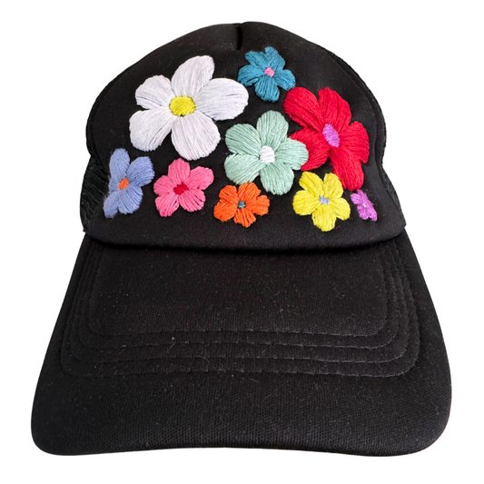 Hand-embroidered colorful flowers on black trucker hat.

