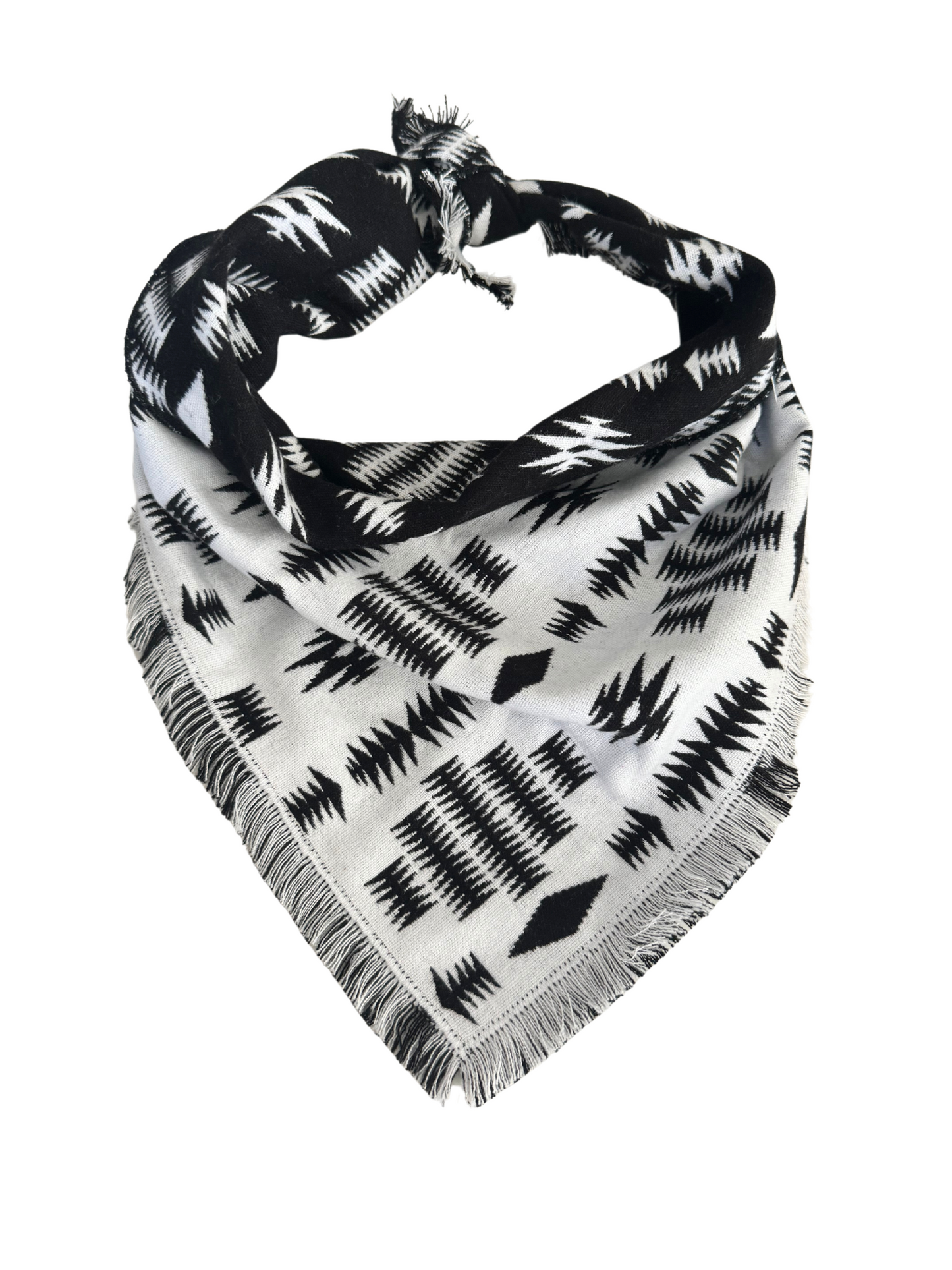 Reversible jacquard bandana scarf featuring a white base with black designs and a black base with white designs, fringed edges, and soft fabric.

