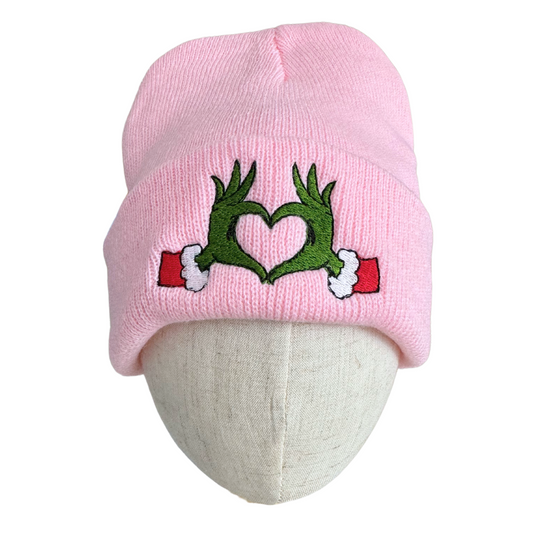 Pink beanie with Grinch heart hands embroidery design inspired by Travis Kelce and Taylor Swift.

